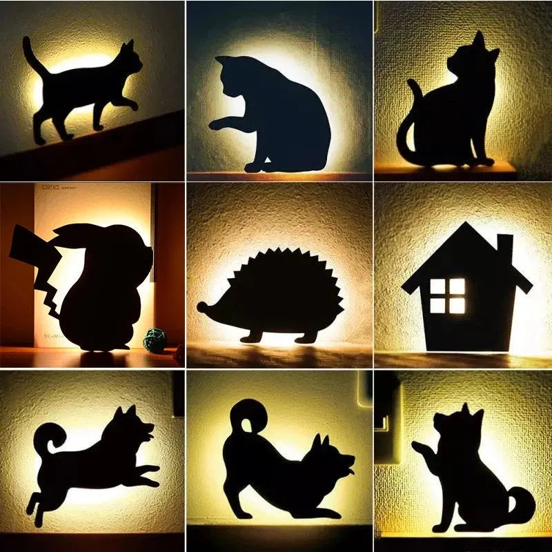 Cat-shaped LED night light with sound sensor on a wall, emitting warm yellow light.