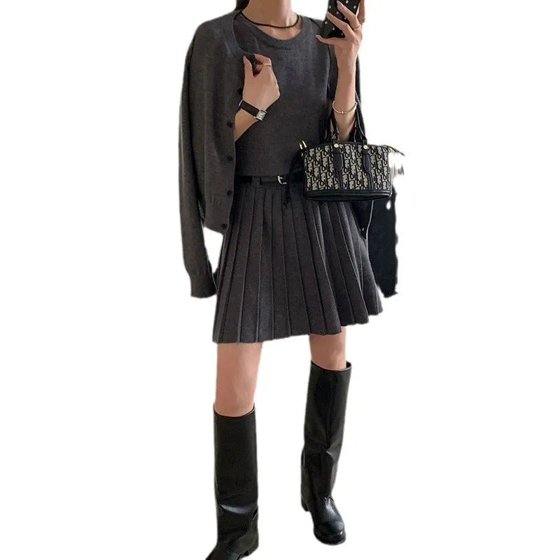 Grey women's knitted vest skirt and cardigan two-piece set with 3D pattern and belt.
