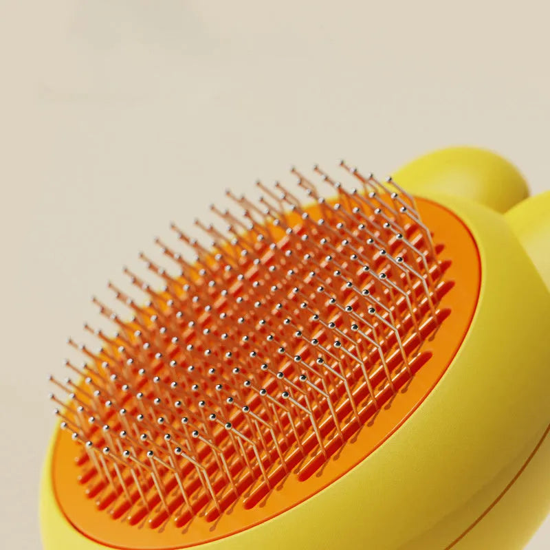 Green self-cleaning cat brush with release button and metal comb for pet grooming