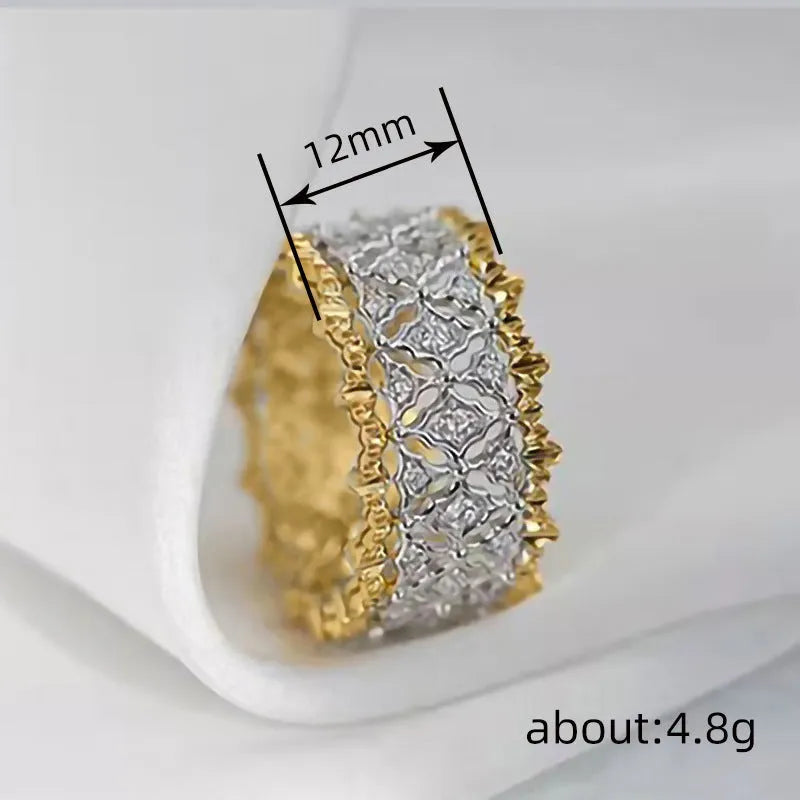 Gold two-tone geometric women's zircon ring on a plain background, showing its round stone and copper construction.