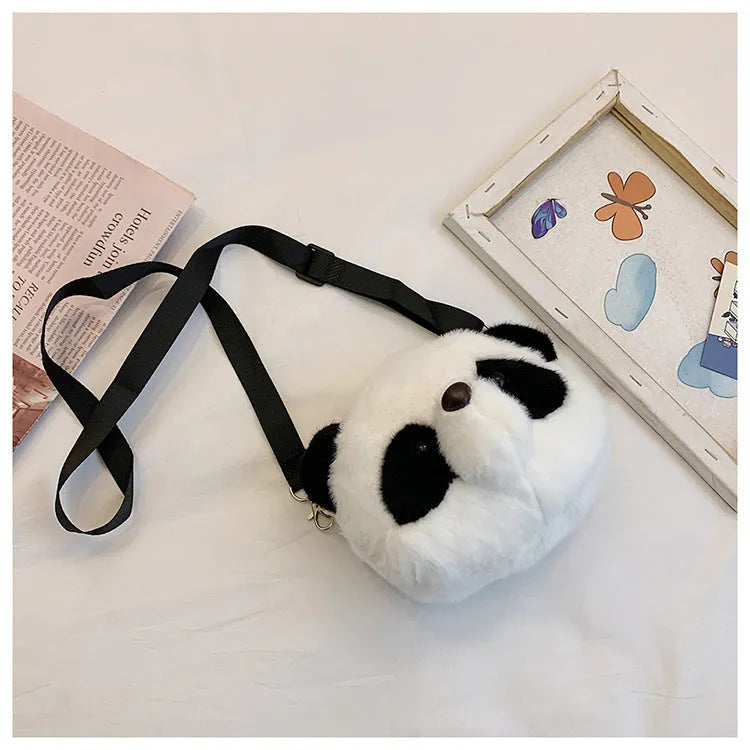 Soft plush panda head cylindrical crossbody bag with an outer sandwich pocket.