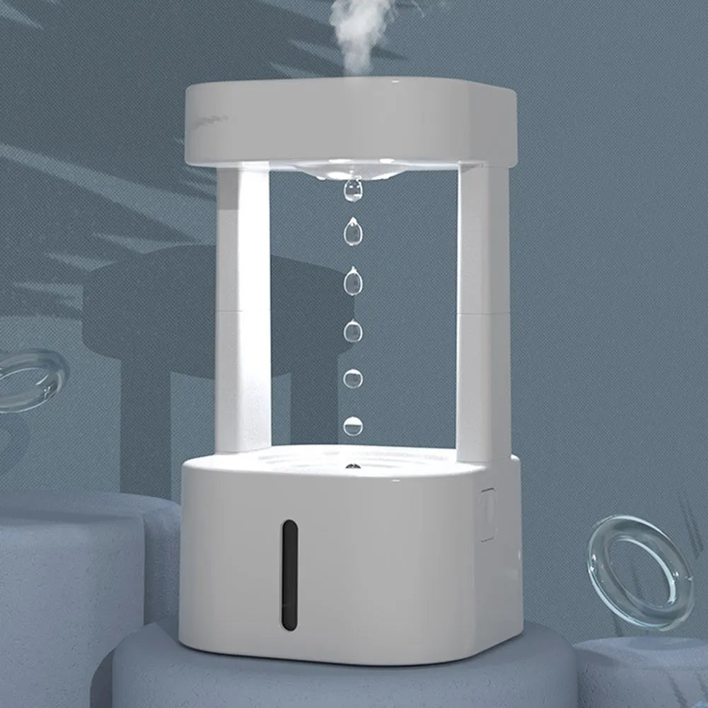 White anti-gravity water droplet USB humidifier with coloured lights on a desk