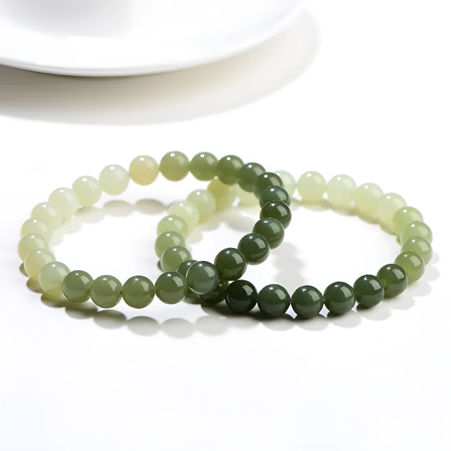 Natural clear water Hetian jade ball bracelet with gradient beads in round or barrel style.