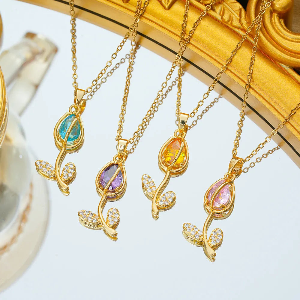 Zircon tulip flower pendant necklace on an adjustable titanium steel chain, shown in a gold colour.