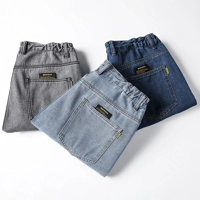 Men's loose straight blue jeans on hanger showing relaxed leg cut and zipper fly