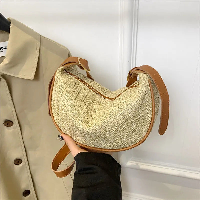 Straw woven crossbody bag showing woven texture and internal phone compartment