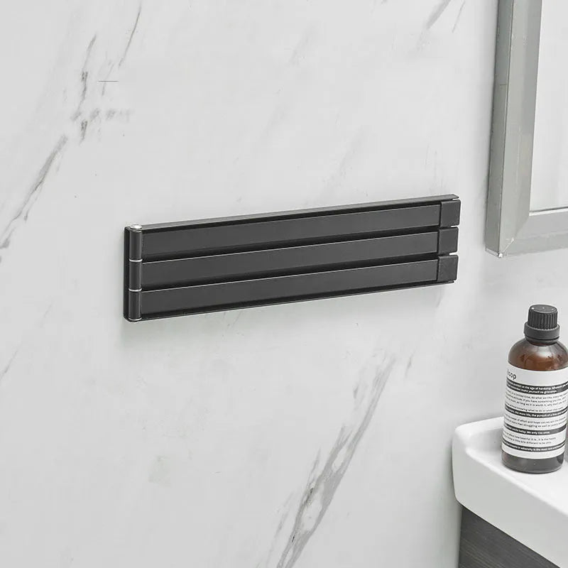 Nordic style folding towel rack in black mounted on bathroom wall without drilling