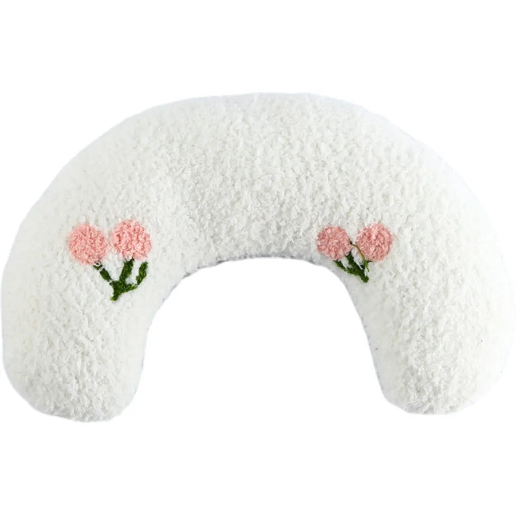 Small U-shaped plush pillow for cats and small dogs in blue, showing quilted faux fur texture.