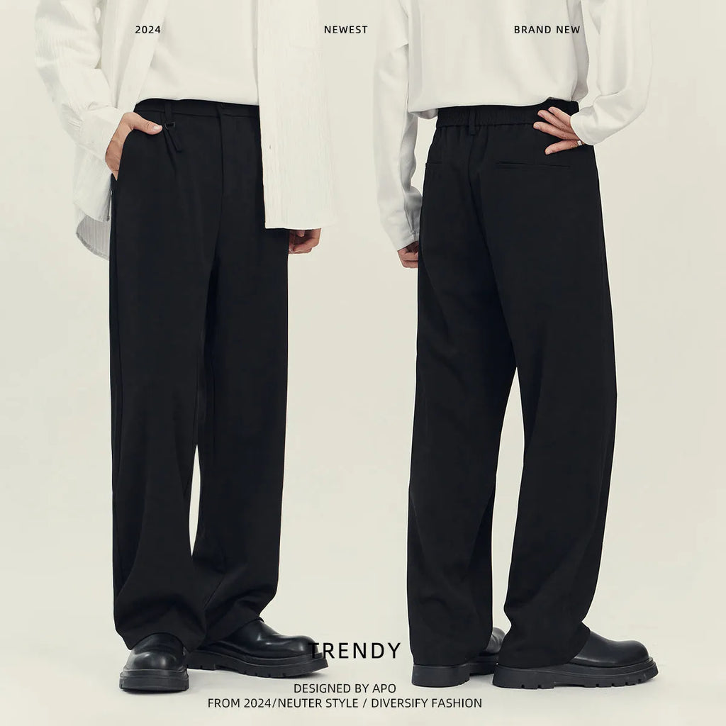 Man wearing black straight-leg business casual trousers with a draping design, made from a polyester blend fabric.