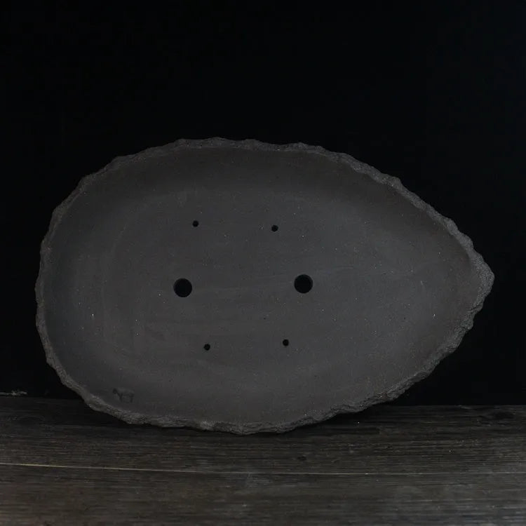 Handmade purple clay flower pot with unique shape showing three size options