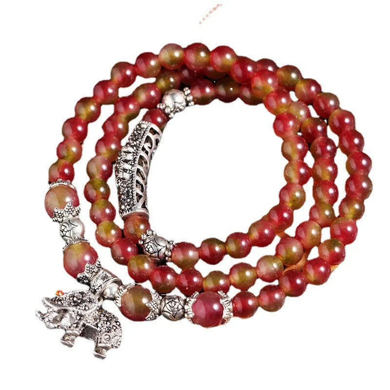 Watermelon crystal bracelet with Chinese knot design showing elephant style beads in geometric shape