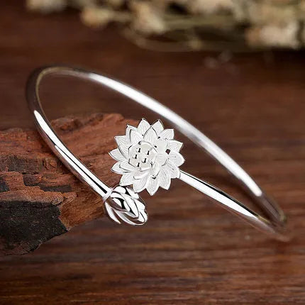 Snow Lotus silver open style bracelet on wrist showing lotus motif and electroplated finish
