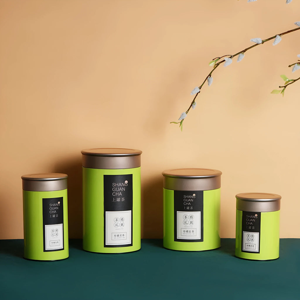 Green metal tin can tea packing box with sealed lid showing measurements of 155mm height and 85mm diameter
