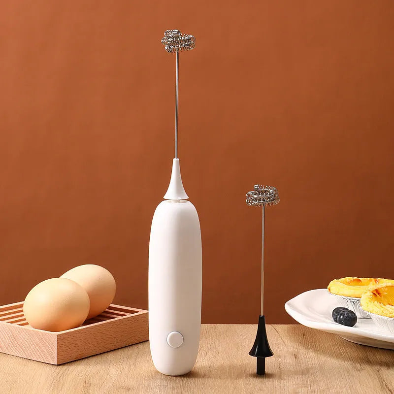 Black and white handheld electric milk frother blender for coffee preparation