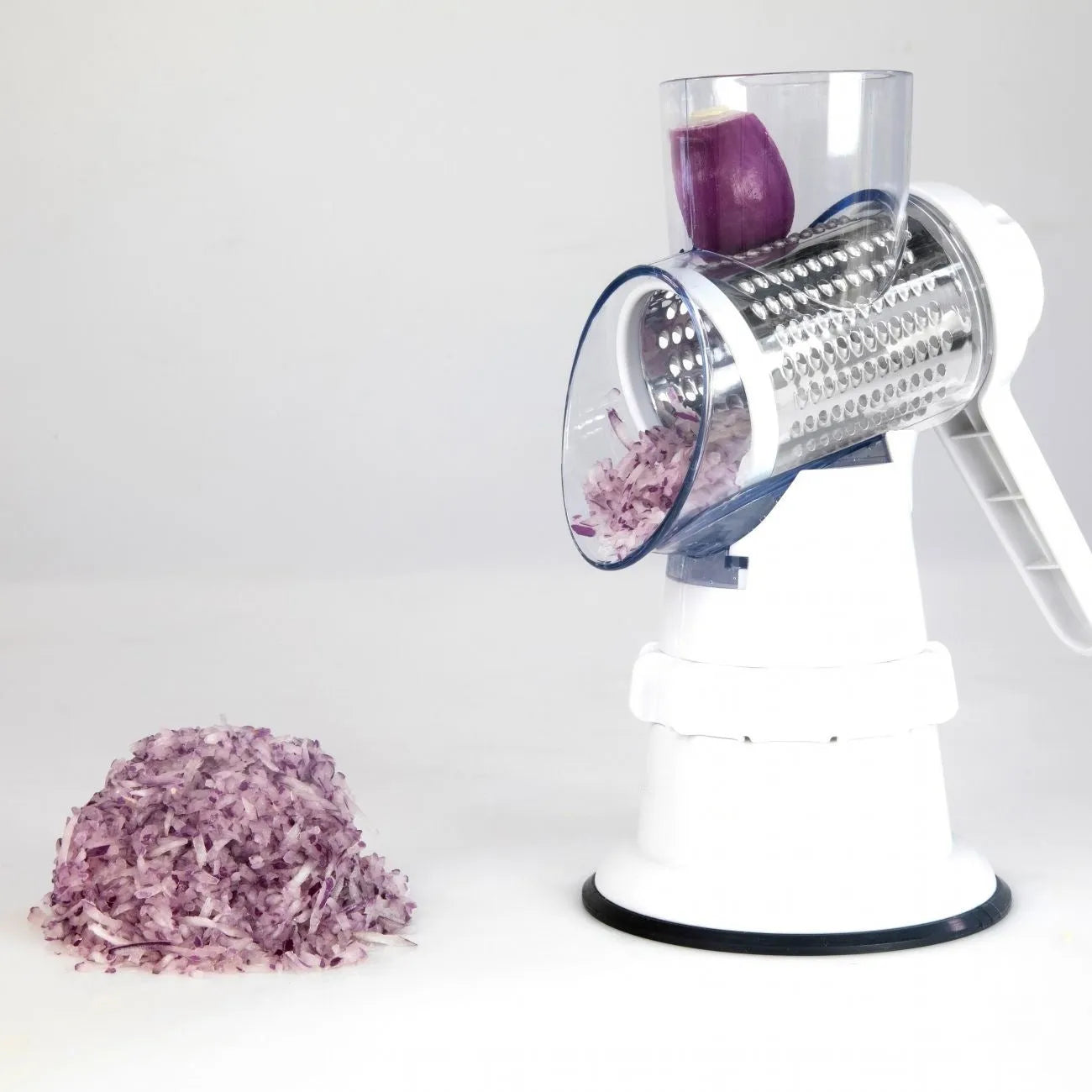 White manual vegetable slicer, grater, and chopper with three stainless steel blades and suction feet.