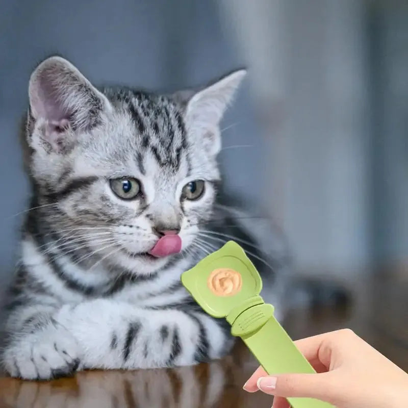 Cat strip feeder spoon in orange, green, and white, 27 x 6.5 cm reusable treat dispenser
