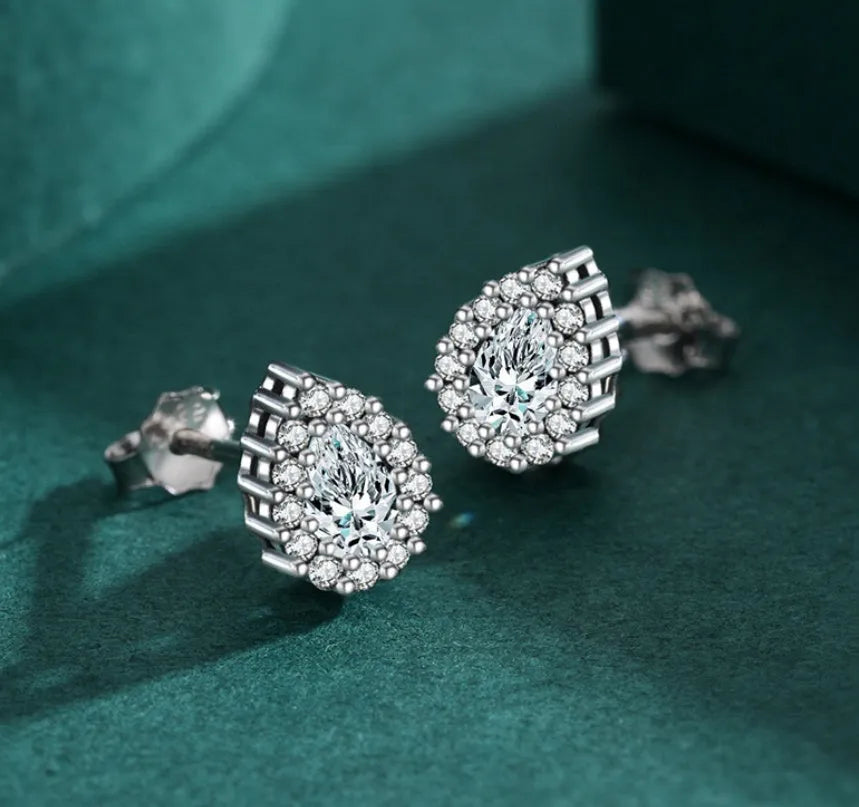 Close-up of women's silver water drop shaped ear studs made from 925 sterling silver.