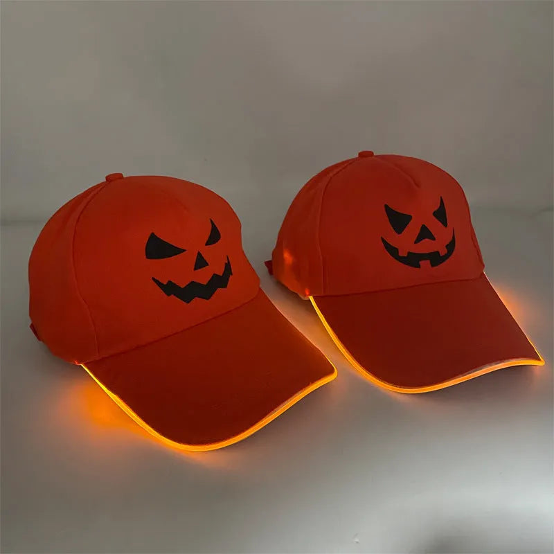 Halloween LED light-up baseball cap showing pumpkin smile yellow light pattern on a black cloth cap with adjustable strap.