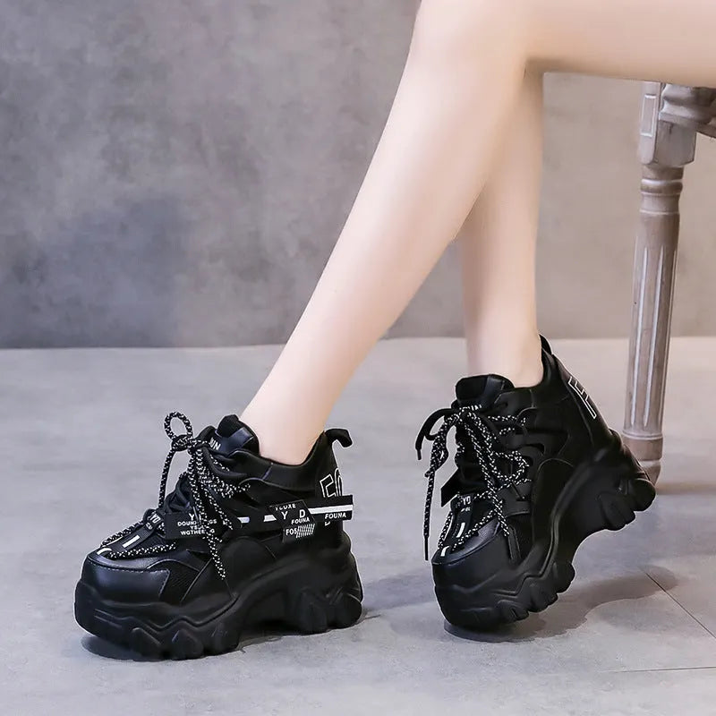 White women's platform sports shoes with mesh upper, cross strap, and a thick rubber sole.