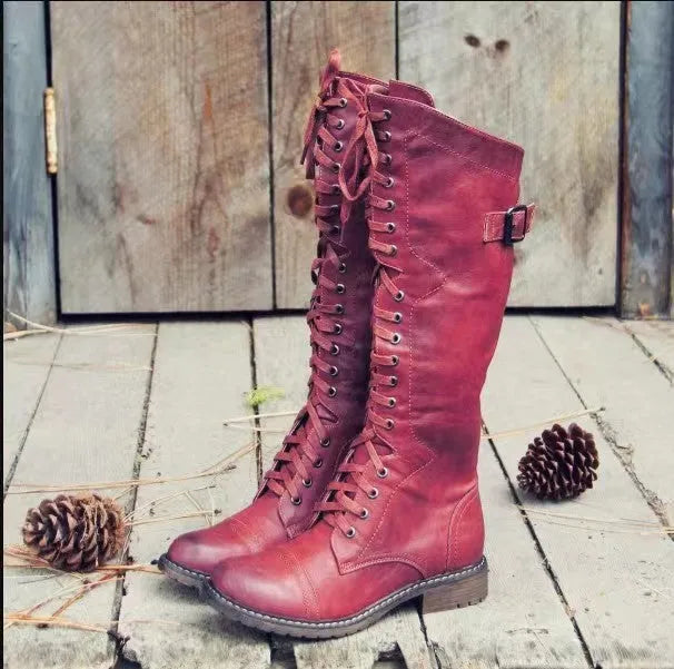 Women's black chunky heel high-leg boots with a round toe and low rubber sole.