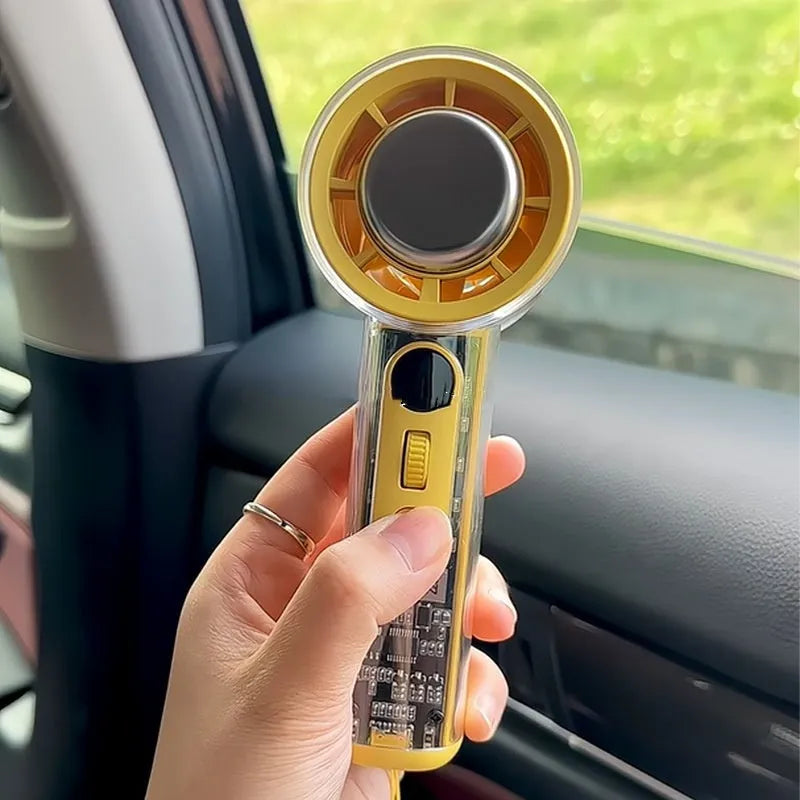 Small yellow handheld fan with refrigeration ice compress function on a table