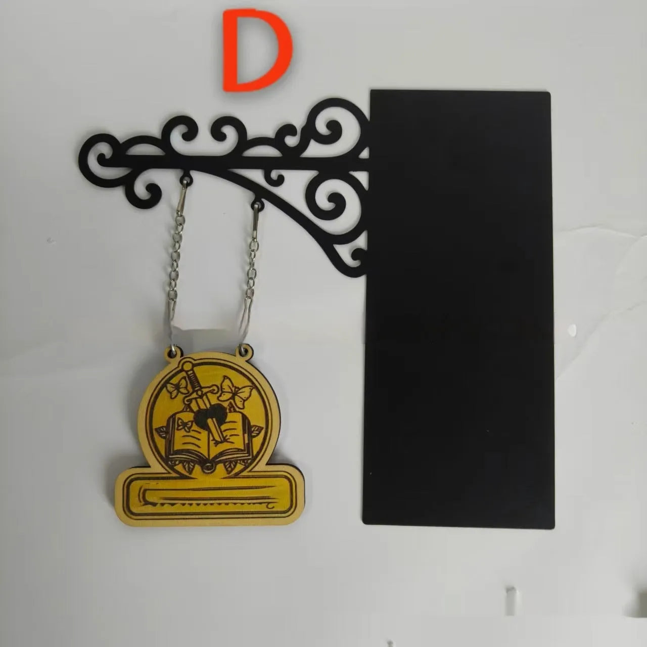 Decorative book nook divider shaped like a medieval tavern sign for shelf organisation