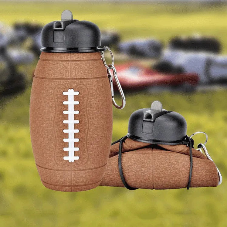 Brown rugby ball-shaped collapsible sports water bottle, 600ml, food-grade silicone, leak-proof seal, non-slip grip.