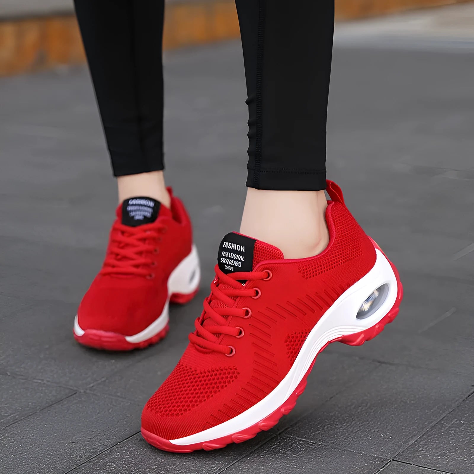 Red low-top women's mesh sneakers with front lace-up and round toe on a flat PU sole.