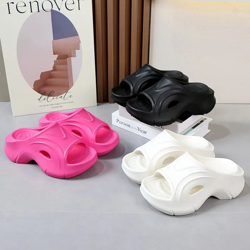 Women's white thick-sole EVA beach slippers with a round toe, shown on a sandy background.