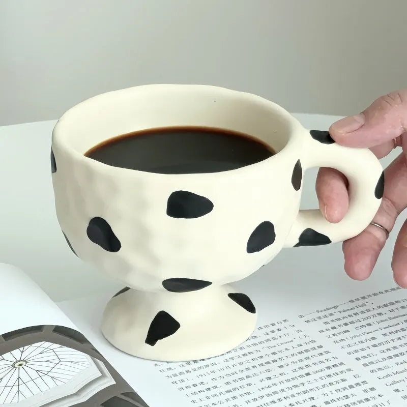 Hand-pinched irregular ceramic mug in solid colour with modern simple design