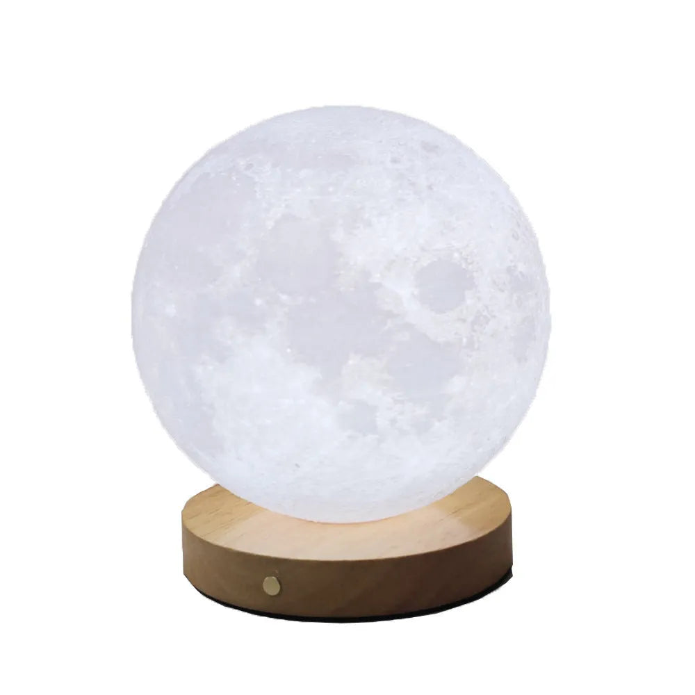 Rotating moon night light on wooden base showing three colour settings