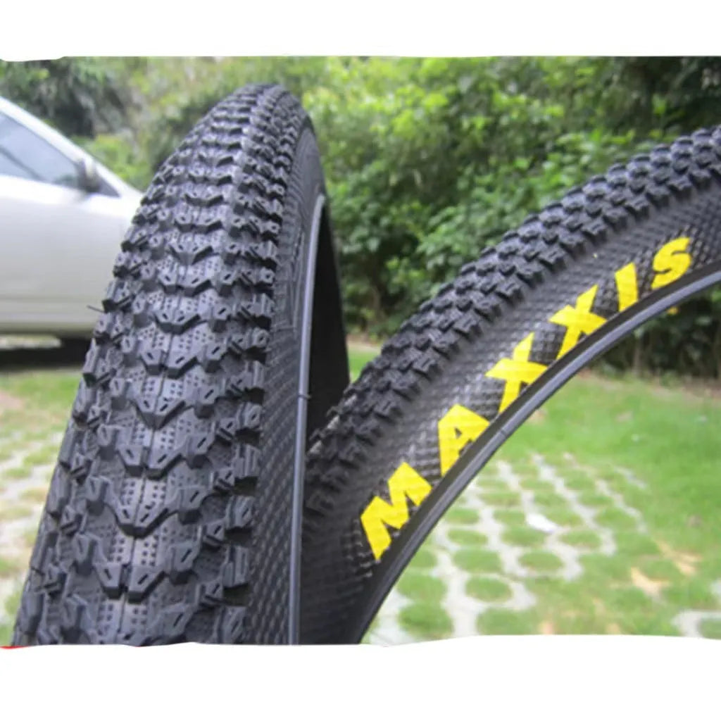 Ultralight mountain bike tyre with reinforced black sidewall shown next to size and weight specifications.