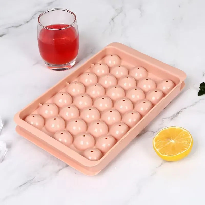 Blue silicone ice cube tray with lid showing 33 round holes for large ice cubes