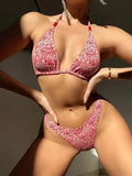 Women's red floral bikini halter swimsuit with lanyard top and shorts on a mannequin.