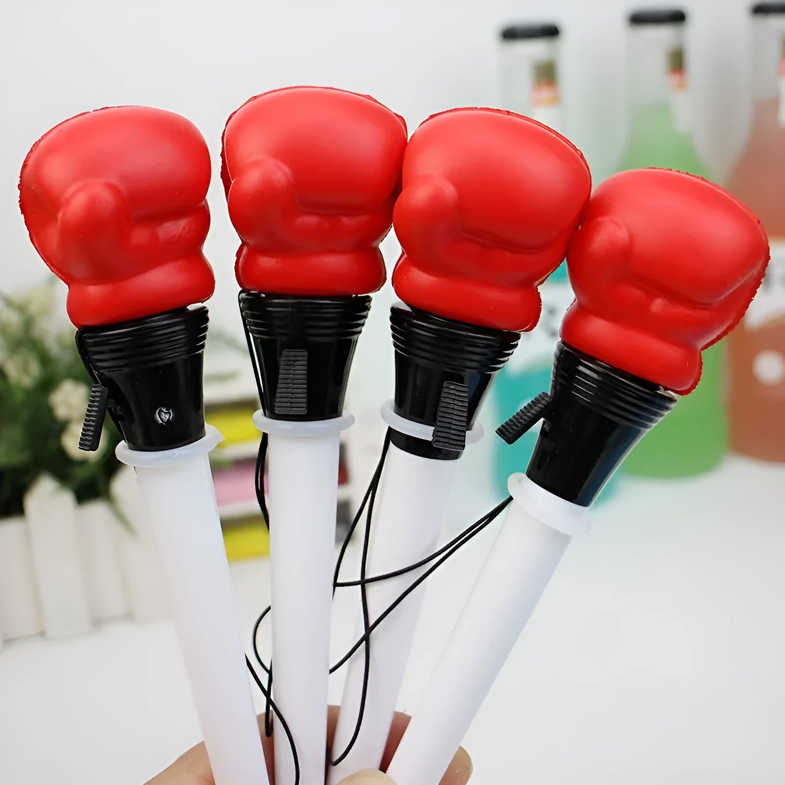 Four black pressure relief pens with boxing press ejection mechanism and 0.7mm bullet tips