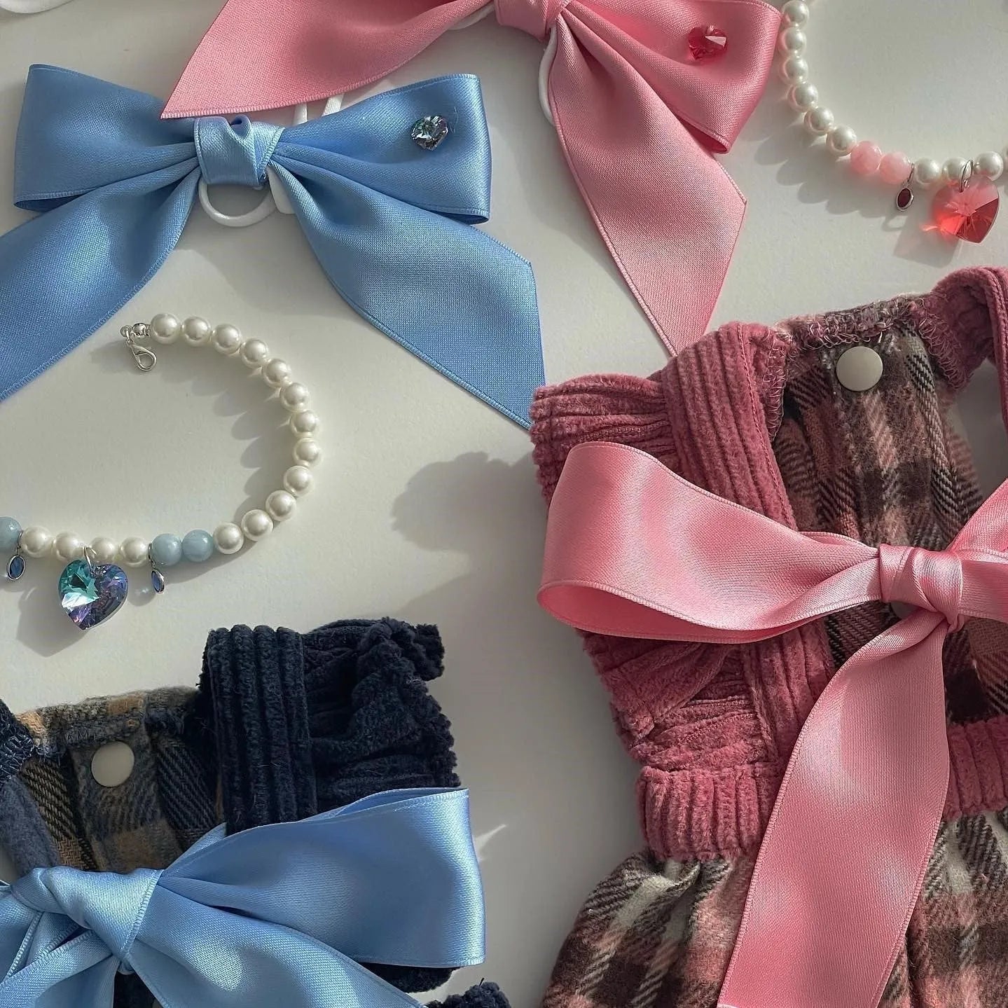 Adjustable blue dog hair band with a large pink princess bow on a white background