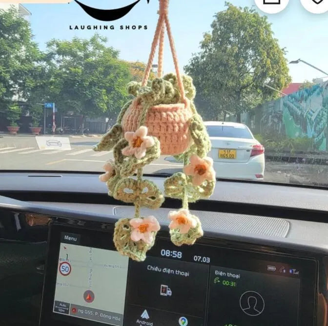 Green and white knitted wool car plant decoration with 8cm base and hanging rope.