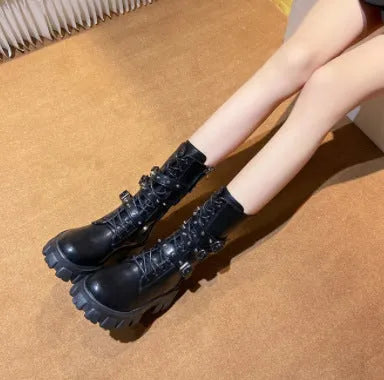 Women's black mid-calf knight boots with a large metal buckle and side zipper detail.