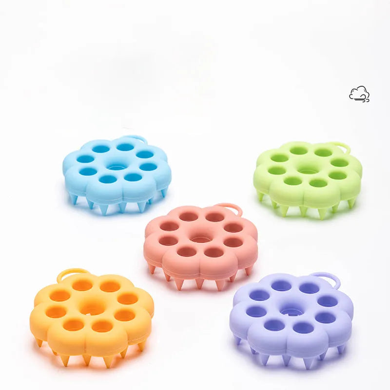 Blue silicone pet grooming brush with flexible massage bristles for wet or dry use on cats and dogs.