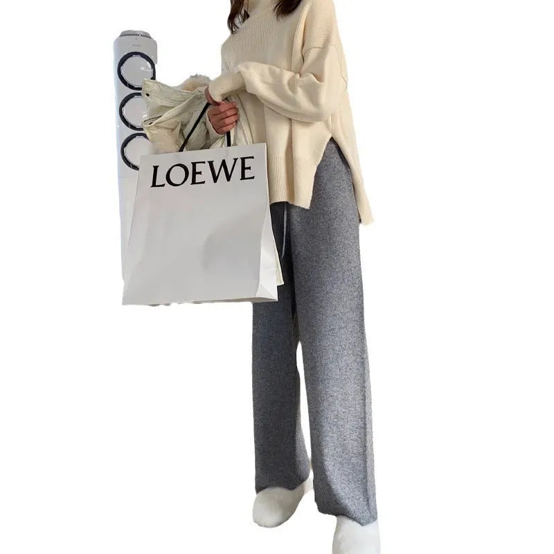 Women's cream white high-waist wide-leg knitted trousers for winter with a drooping mopping hem.
