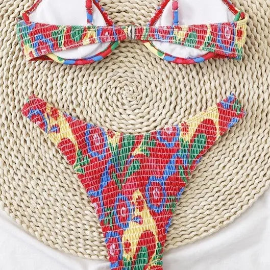 Red floral patterned women's underwire triangle bikini top and briefs set on a white background.