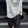 Men's loose fit round neck T-shirt with a printed Korean style design on solid colour fabric.