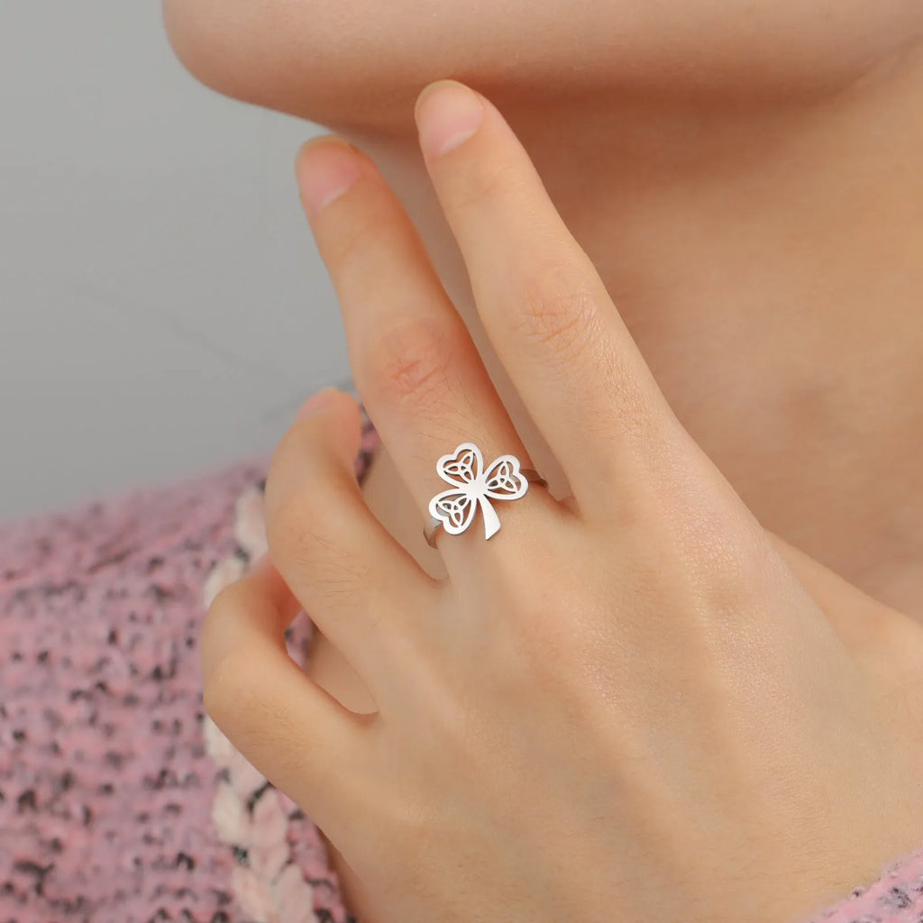 Women's hollow stainless steel fashion ring in gold or steel colour on a size chart.