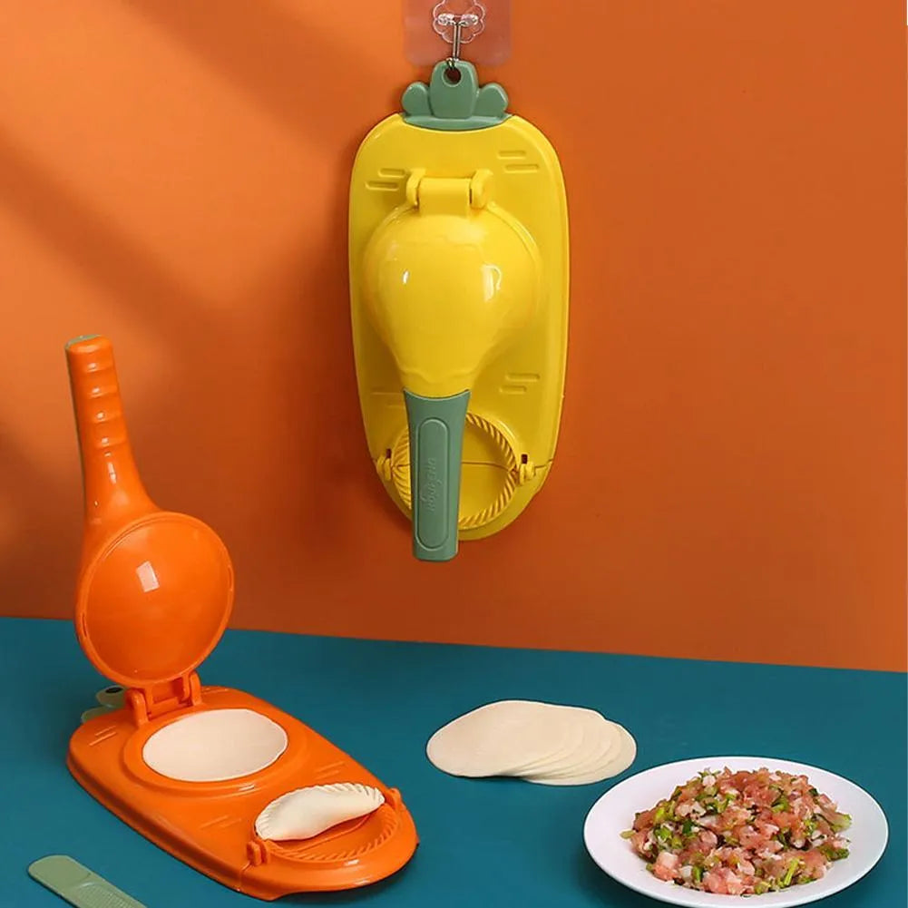 Orange and white plastic manual dumpling press tool with ergonomic handle on a kitchen worktop.