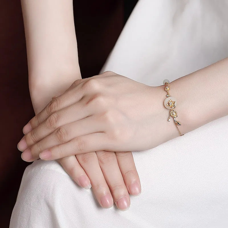 Women's Hetian jade lotus peace buckle bracelet in 925 silver with antique gold or silver plating