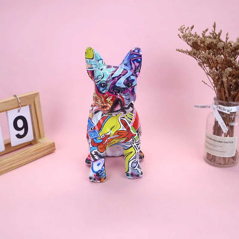 Graffiti coloured solid resin French Bulldog statue on a white background.