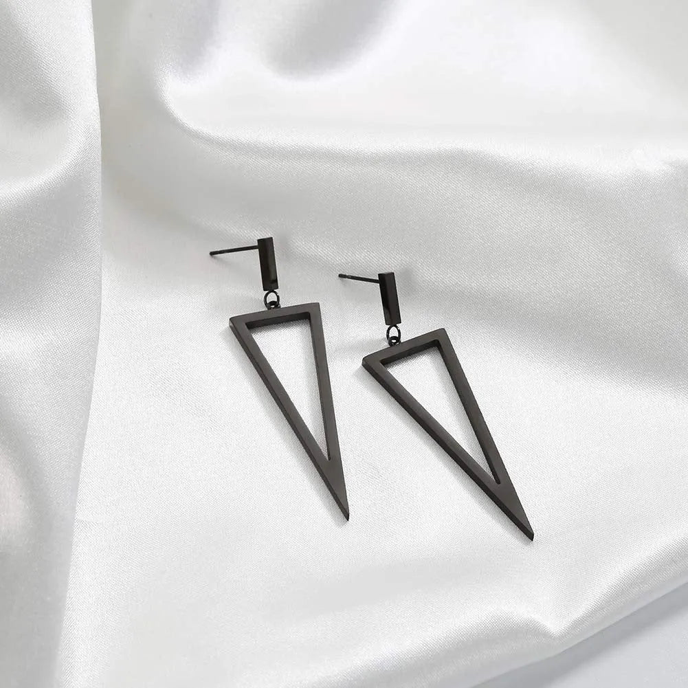 Black metal triangle earrings with electroplated finish on a neutral background