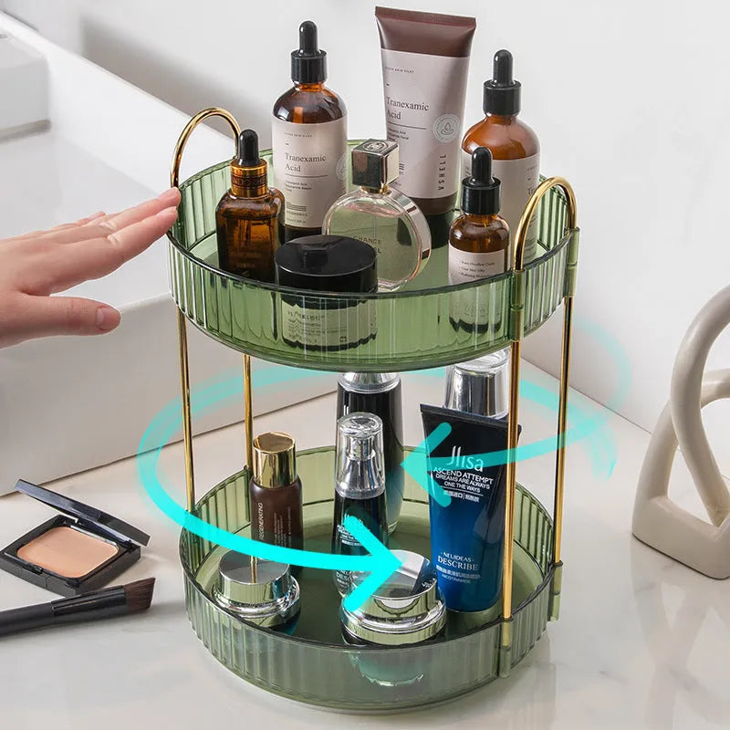 Three-layer rotating bathroom cosmetics storage rack in green on a desktop, with bottles on each tier.