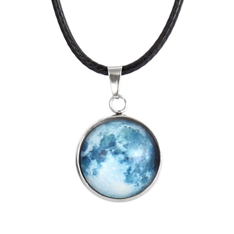 Luminous moon and constellation glass pendant on a silver alloy necklace chain with an extension piece.