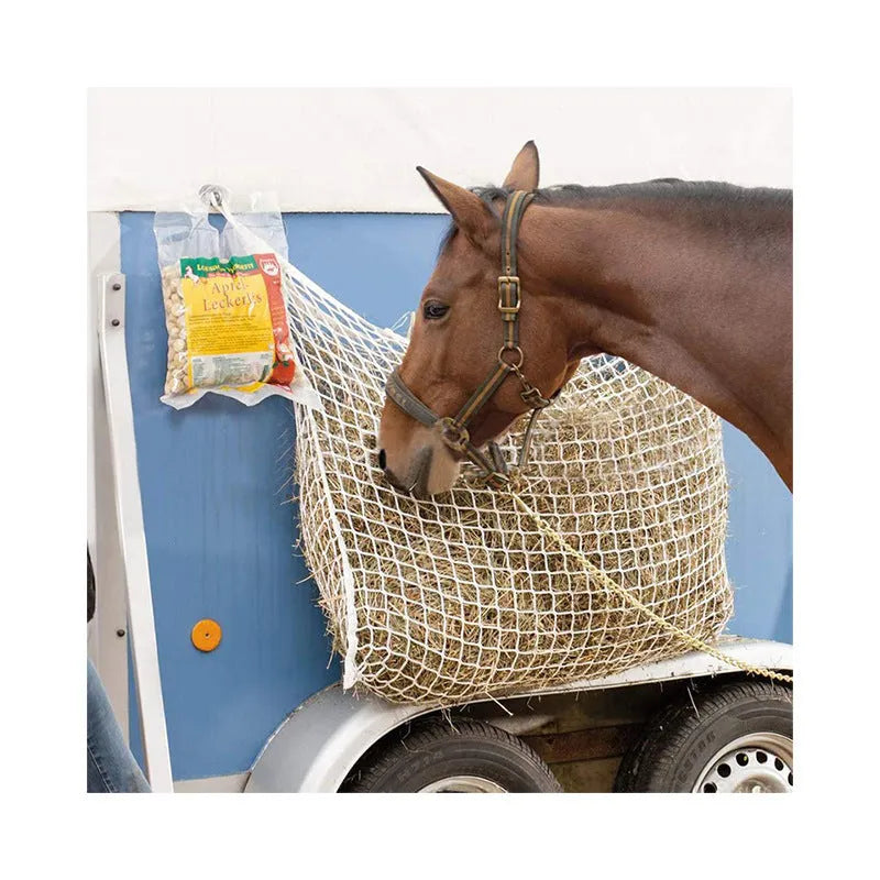 Black woven grid horse feeding bag hanging, showing its open structure and size.